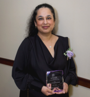 Sara Azam holding the crystal keepsake